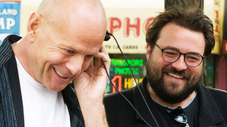 Cop Out Bruce Willis listens to headphones next to Kevin Smith