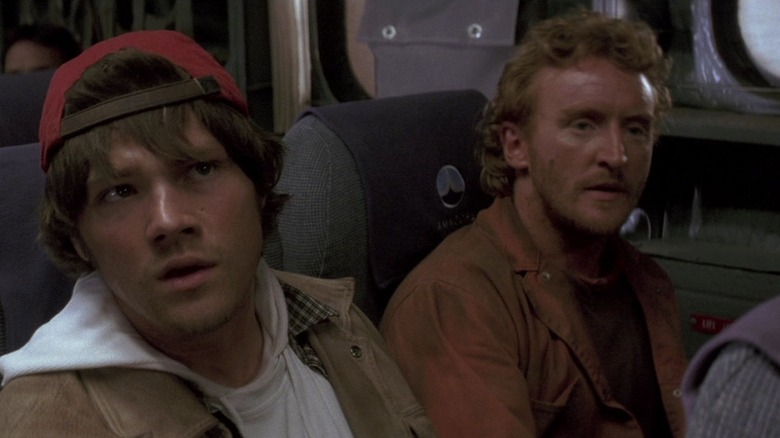 Jared Padalecki in a red baseball cap on a plane in Flight of the Phoenix