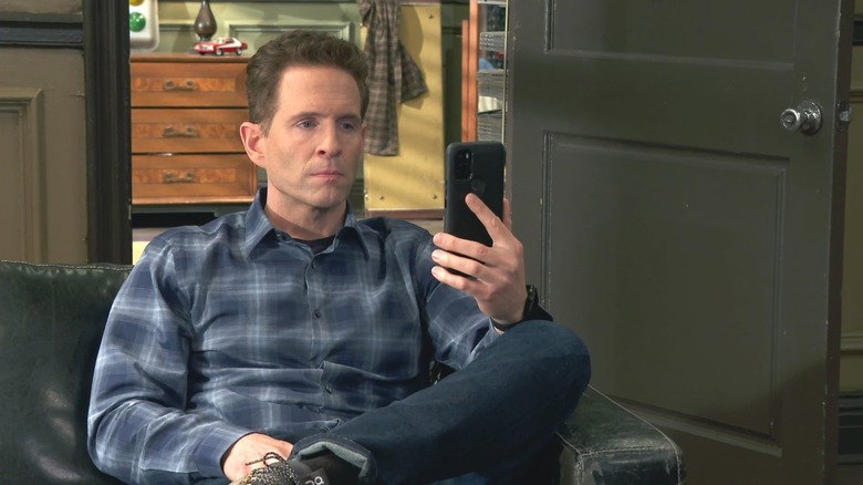 Glenn Howerton holding a phone in It's Always Sunny in Philadelphia