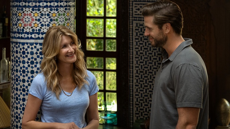 Laura Dern and Liam Hemsworth look at each other in  Lonely Planet