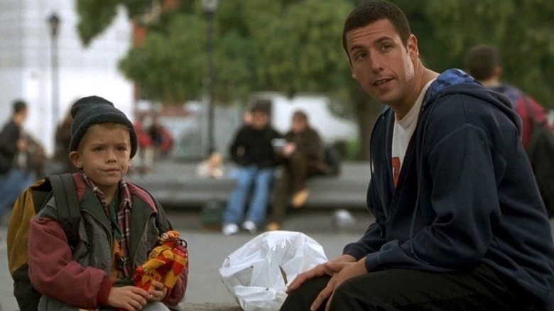 Adam Sandler Cole Sprouse sit on bench in New York