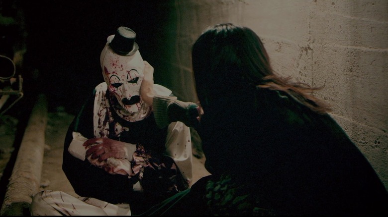 Art allows the Cat Lady to touch him in Terrifier