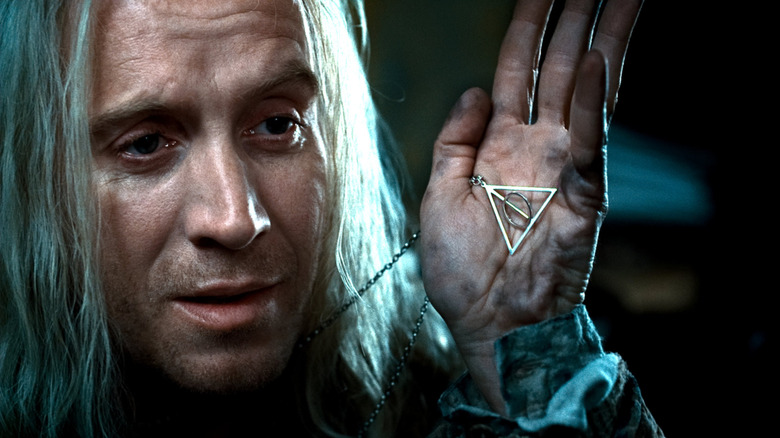 Xenophilius Lovegood showing Deathly Hallows necklace